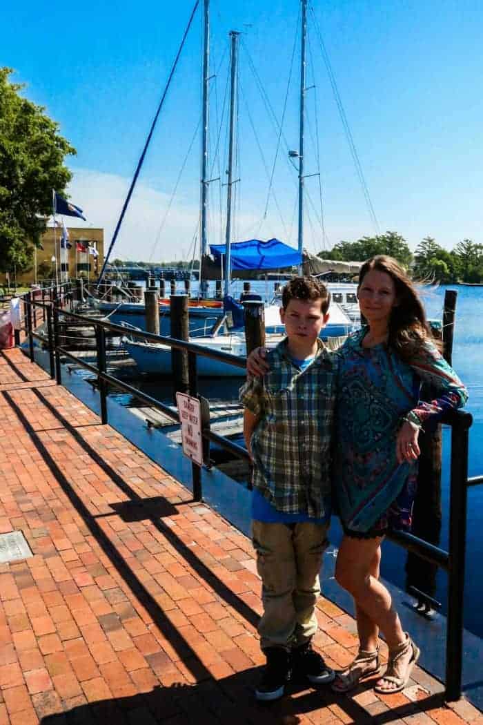 blogger shasta walton posing with son at the marina in Elizabeth City, NC 
