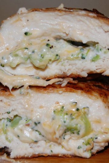 Sliced chicken breast stuffed with a creamy cheese and broccoli filling, revealing a tender, juicy interior.